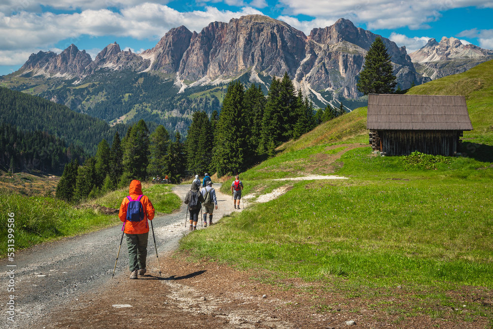 Fototapeta premium Hiker group with backpacks on the hiking trail, Dolomites, Italy