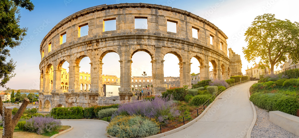 Panorama medieval Ancient Roman Amphitheater in Pula at dawn, Croatia. Architecture and landmark of Croatia. Travel concept background.