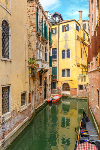 Obraz na płótnie View on the narrow cozy streets of the canals with parked boats in Venice, Italy. Architecture and landmark of Venice. w salonie