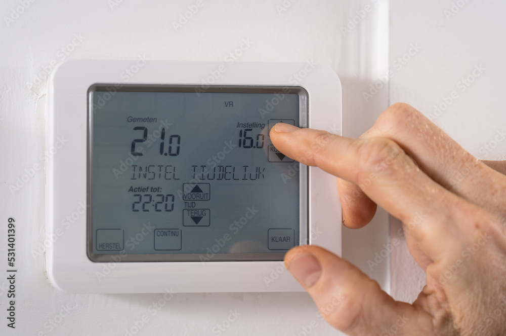 Lowering the temperature on a thermostat because of the high gas prices. Lowering the temperature on a thermostat because of the high gas prices.