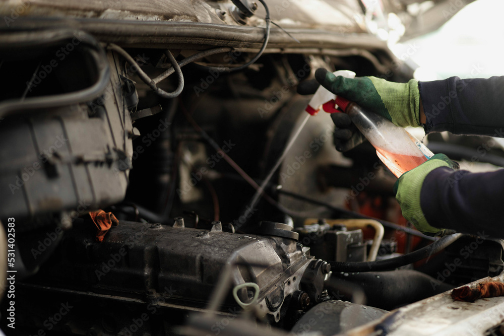 cleaning the engine with a spray, cleaning the valve cover.