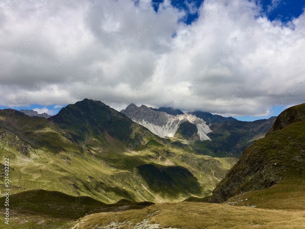 Fototapeta premium high mountains with blue sky and white clouds in summer