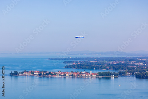 Zeppelin aircraft flying over the city of Lindau in the Bodensee lake, Germany, during summer