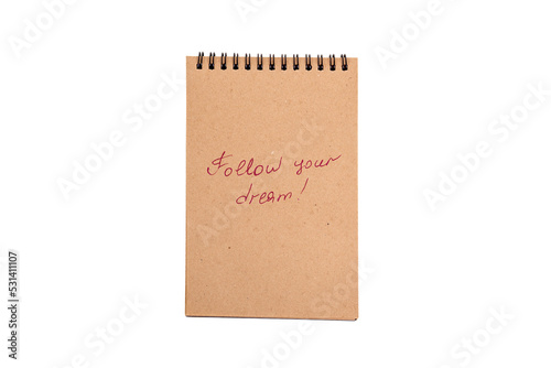 Positive statements. A phrase on a note sheet on a white background. Motivational concept with handwritten text. Craft notebook. phrase follow your dream © Diana