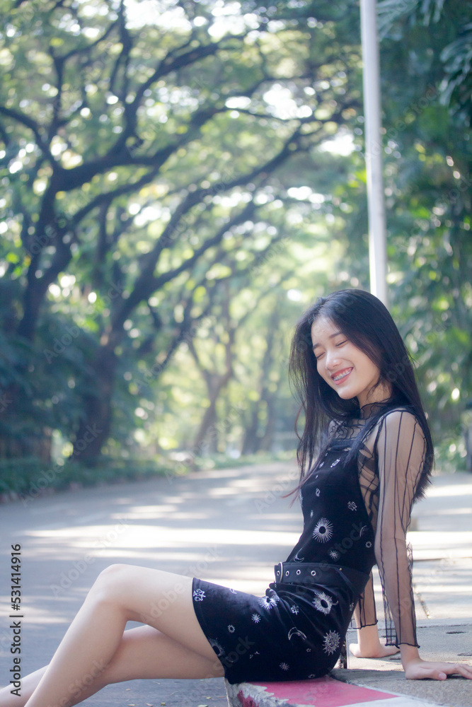 Naklejka premium asia thai teen black dress beautiful girl smile and relax