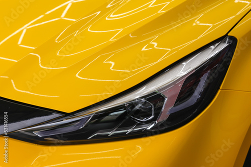 Close up side of headlight on a yellow car.Selective focus.