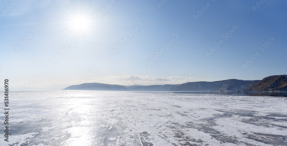 Winter landscape with mountains and Lake Baikal in Siberia on sunny day. Natural background.