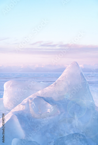 Obraz na plátně Winter landscape with ice hummocks glittering in the sun and mountains of Lake Baikal in Siberia at sunset