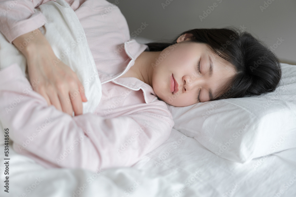 Asian woman sleeping in bed