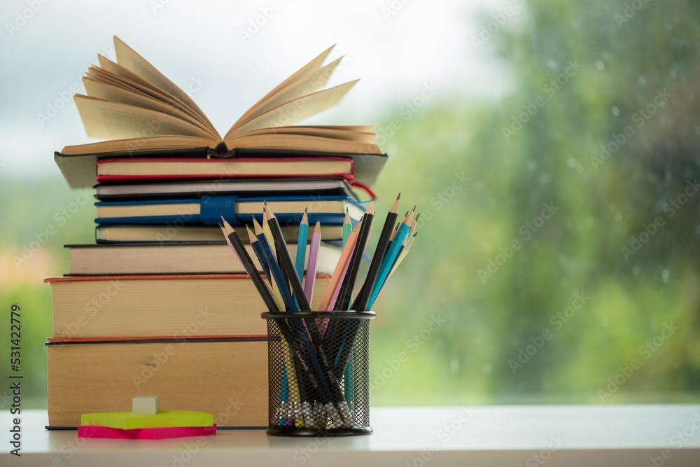Object education green nature background with stack of ancient books or old bible, open paper book on wooden table with copy space. concept of back to school, research study Object education green nature background with stack of ancient books or old bible, open paper book on wooden table with copy space. concept of back to school, research study