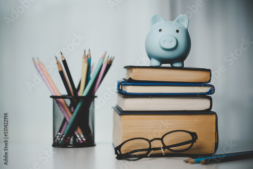 close-up education object with stack money coin-cash dollar and glass jar on background. Concept to saving money income for study, Calculating student finance costs and investment budget loan