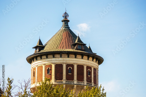 Photography A brown old building in the middle of the city center with a blue sky