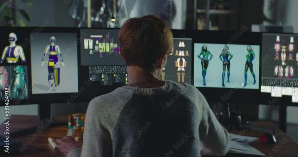 Female Fashion Designer Working in Her Home Office. Young Woman Creating 3D VR Models on Computer and Makes Corrections to Paper Sketches. Night City Background. Female Fashion Designer Working in Her Home Office. Young Woman Creating 3D VR Models on Computer and Makes Corrections to Paper Sketches. Night City Background.