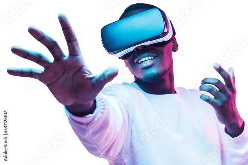 African man in vr glasses, playing video games with virtual reality headset, trying to touch metaverse photo