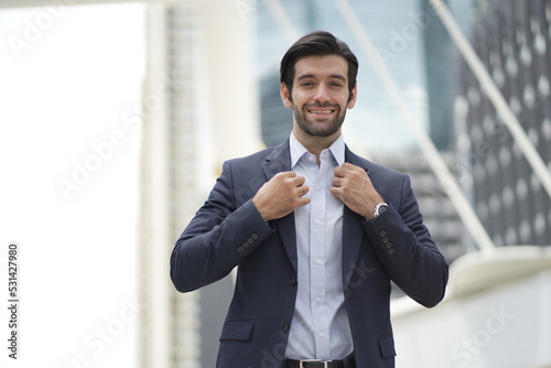 Portrait of a charming businessman dressed in suit smiling 