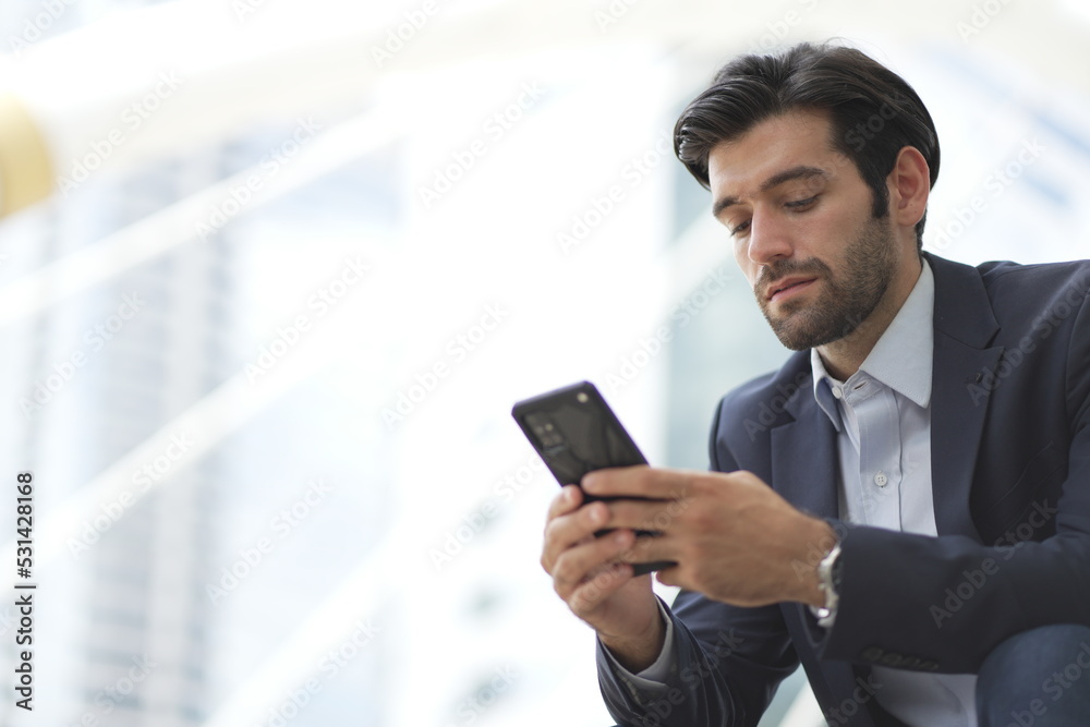 Confident businessman with formal suit using smart phone, smiling, talking and checking email. Confident businessman with formal suit using smart phone, smiling, talking and checking email.