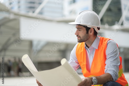 Wallpaper Mural Architect or engineer with blueprints. Cauacsian Engineer checking plan on construction site. modern structure. Torontodigital.ca