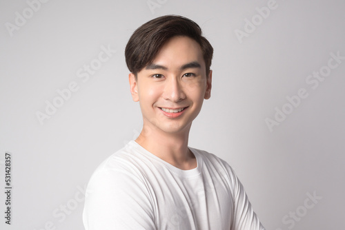 Portrait of young asian man over white background studio.