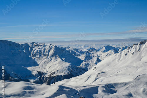 Snow covered mountains under a blue sky