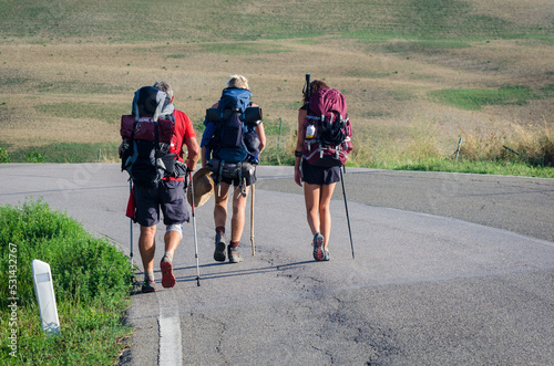 Tre Pellegrini in cammino lungo la Via Francigena in Valdorcia in Toscana photo