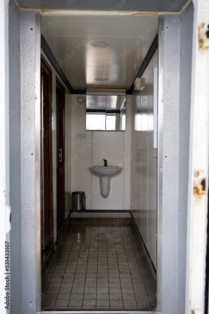 Small public washstand area. Wet floor. 