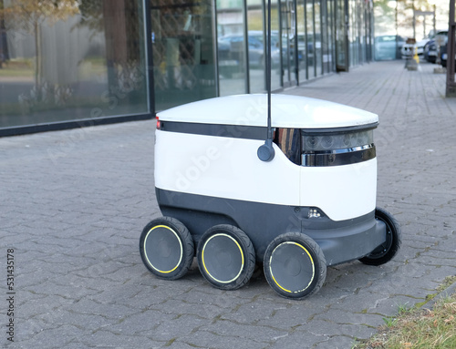 Autonomous delivery robot on Tallinn, Estonia. Estonian company developing autonomous delivery vehicles. Concept of future, technology, unmanned courier robot.