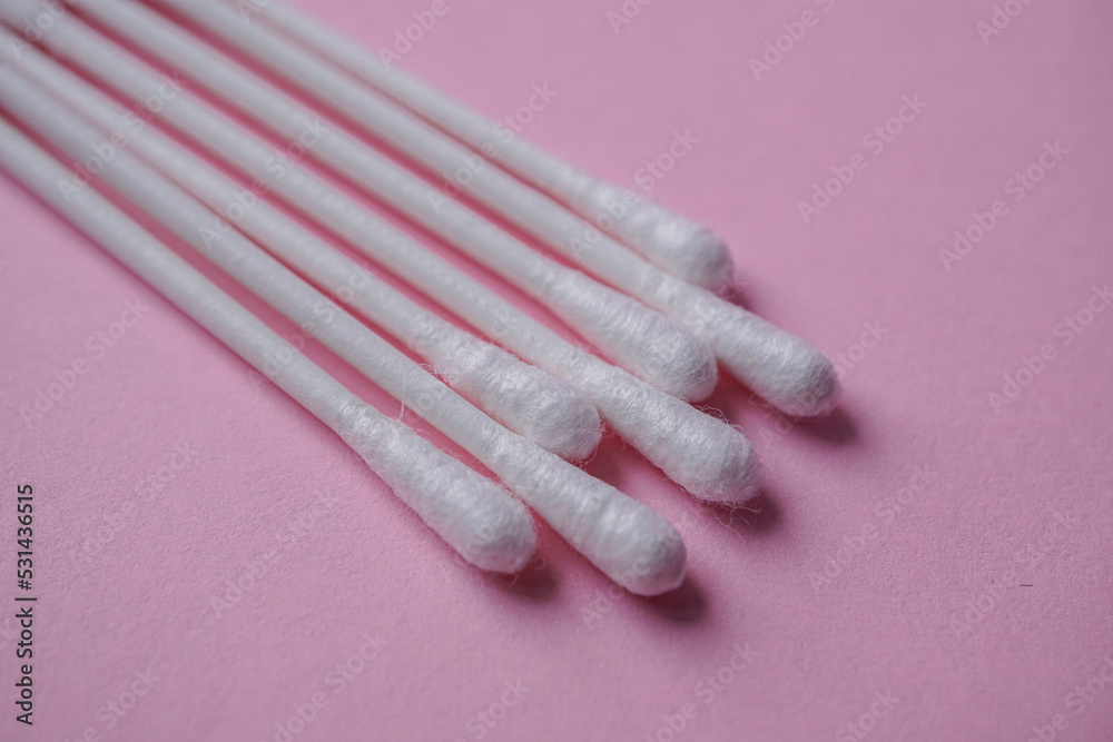 cotton swabs on the pink background, cosmetics and hygiene cotton swabs on the pink background, cosmetics and hygiene