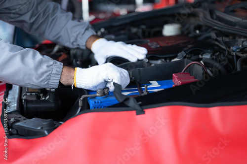 Close-up hands of auto Arab mechanic man are using the wrench to repair and maintenance auto engine is problems at car repair shop. Concepts of car care check and fixed and services insurance.