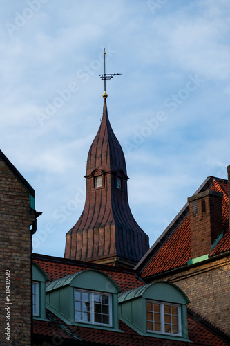 Tower and roofs against blue sky in Lund Sweden