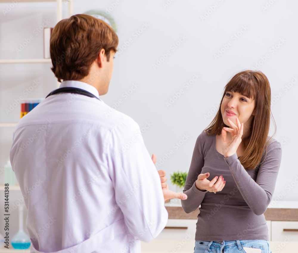 Deaf-mute female patient visiting young male doctor Deaf-mute female patient visiting young male doctor