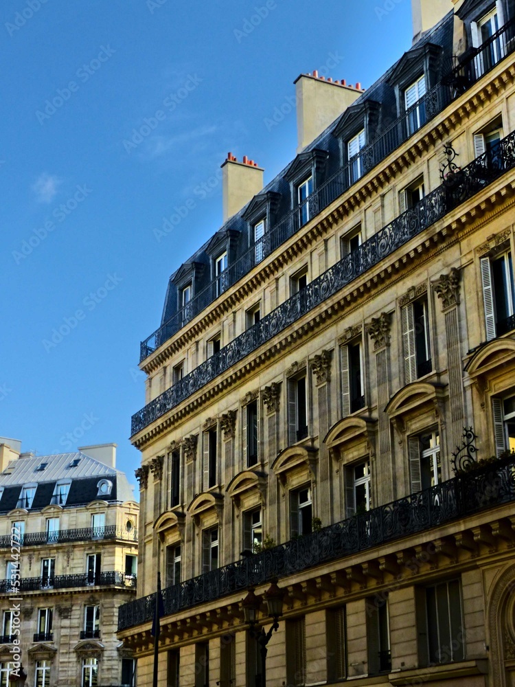 Paris, September 2022 : Visit of the magnificent city of Paris, Capital of France - View on different facades of buildings built by Baron Haussmann