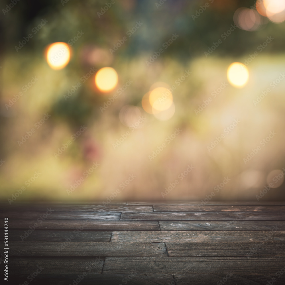 Blurred autumn background with golden bokeh and empty wooden table for a thanksgiving decoration and sesonal messages. Blurred autumn background with golden bokeh and empty wooden table for a thanksgiving decoration and sesonal messages.