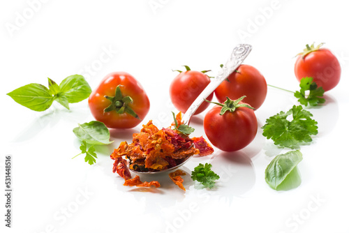 small pieces of dried tomatoes next to fresh tomatoes