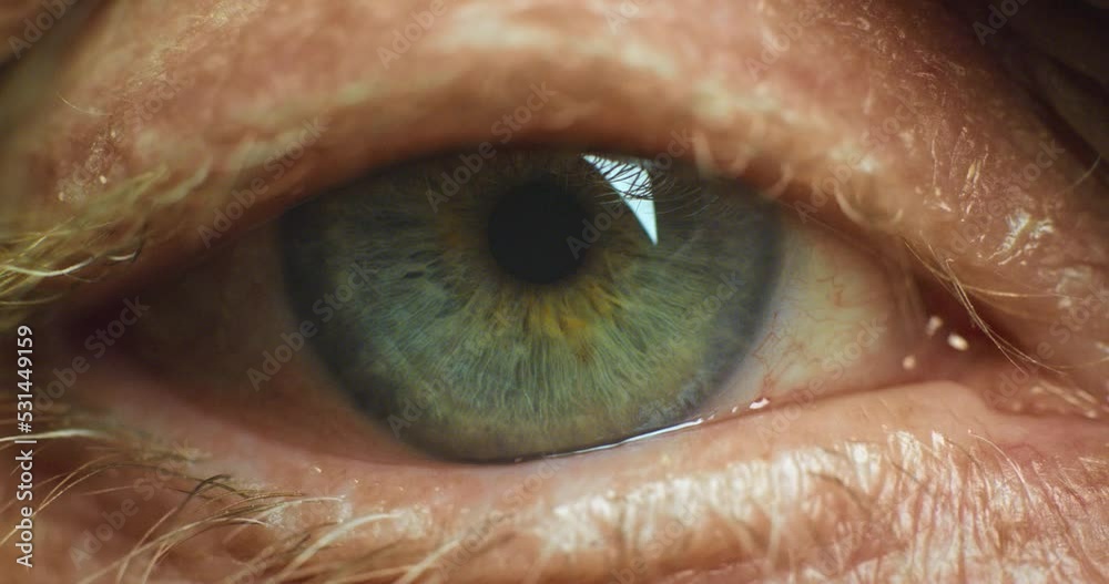 Eyes, vision and health with a senior man blinking his eye at a test or exam at the optometrist for prescription glasses or contact lenses. Face, ocular and wrinkles with an elderly male closeup