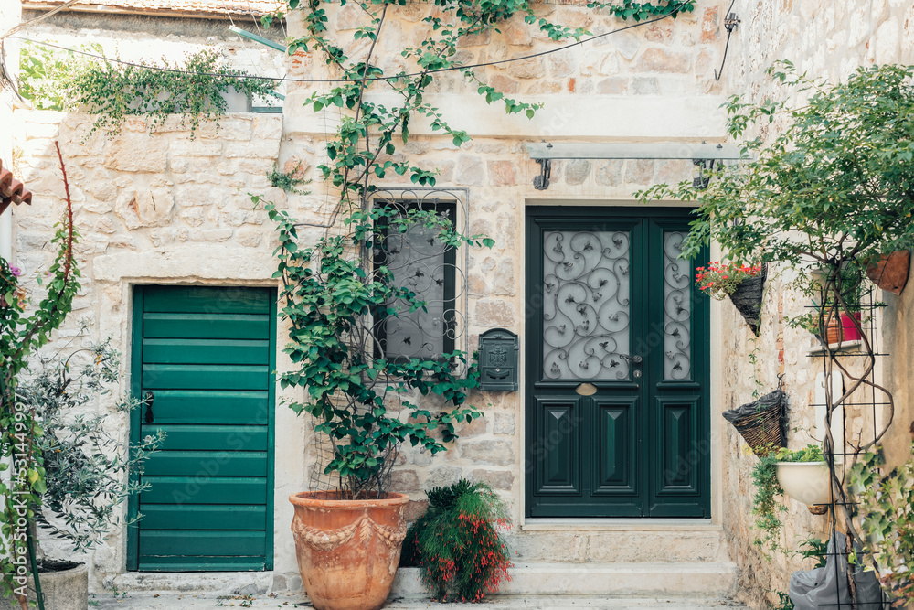 Decoration of the facade of stone house, flowers in pots, countryside style Decoration of the facade of stone house, flowers in pots, countryside style