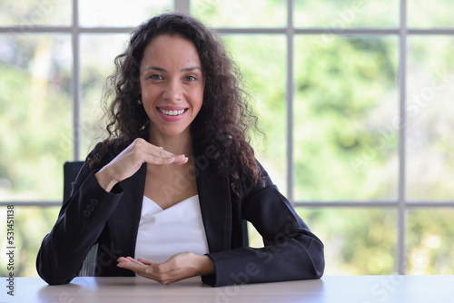 Attractive professional latin female in classic suit show protecting something on table. Businesswoman sitting at home workplace. Property insurance and security concept Free Download Attractive professional latin female in classic suit show protecting something on table. Businesswoman sitting at home workplace. Property insurance and security concept - GFXLoad