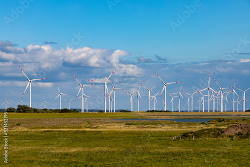 Wind farm with many wind turbines on the horizon