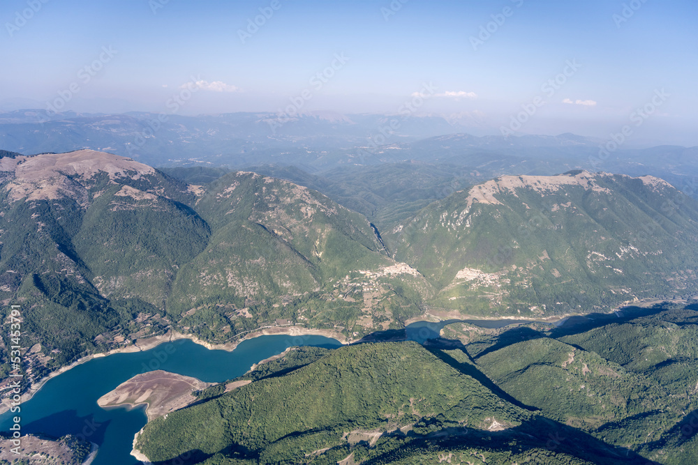 Turano lake with Ascrea and Paganico Sabino hilltop villages, aerial, Italy