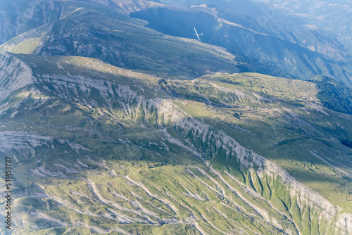 glider over Gorzano range barren slopes. aerial, Italy photo