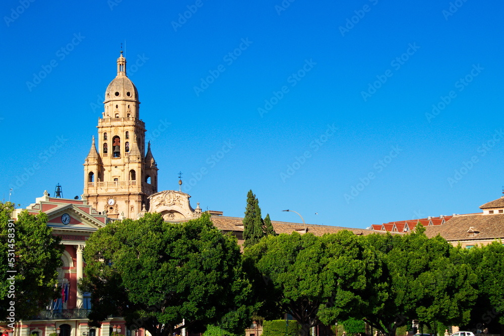 Nice panorama of the tower of the Cathedral of Murcia and the facade of the Town Hall on a sunny day