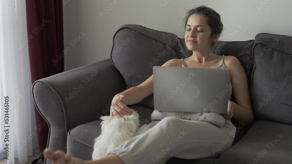 The girl studies from home online, watches webinars, does shopping. Slow motion The girl studies from home online, watches webinars, does shopping. Slow motion
