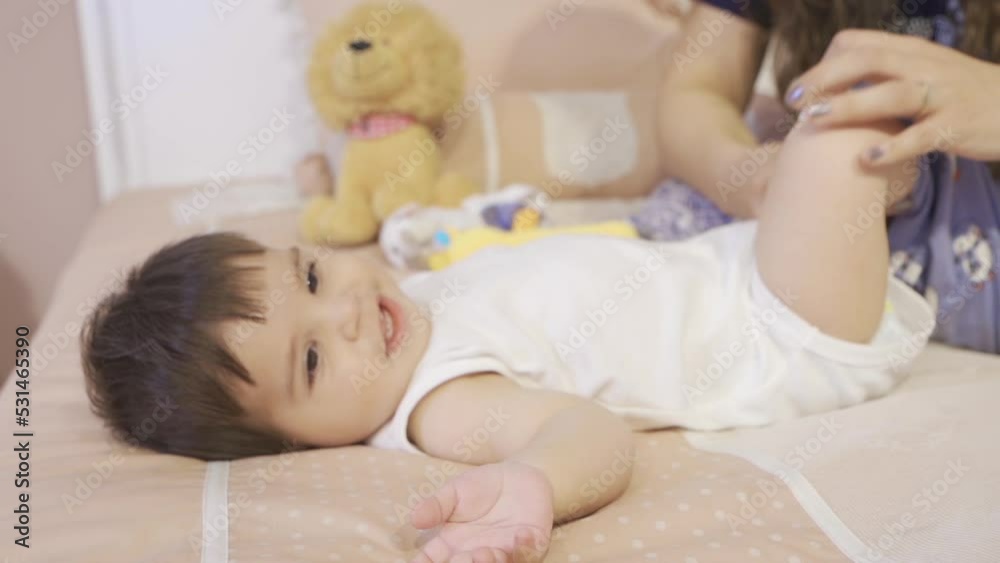 Laughing baby and mother.
The baby laughs while the mother dresses her baby.
Laughing baby and mother.
The baby laughs while the mother dresses her baby.