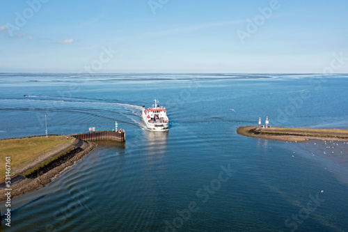 Aerial from the ferry from Schiermonnikoog arriving in the harbor from Lauwersoog in the Netherlands photo