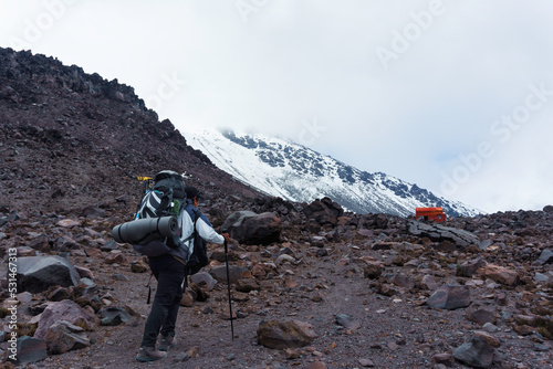 Mountaineer man climbs on top snowy mountain photo