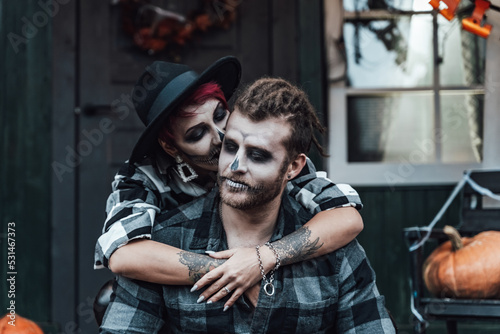 Russia Moscow 22.10.2020 Scary love couple,man,woman.Family,mother,father celebrating halloween.Terrifying skull face makeup. Witch stylish images.Horror,fun at children's party on porch.Hats,jackets