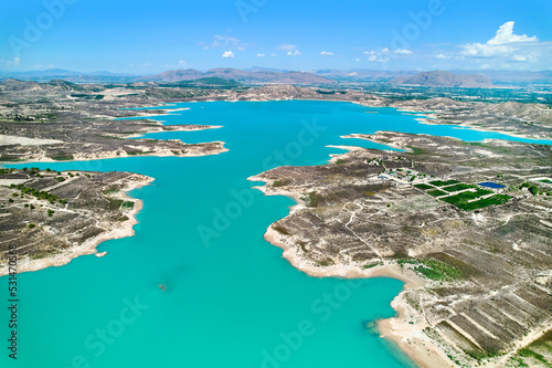 Drone point of view Embalse de La Pedrera large turquoise colored lake used as source of water supply, no people, sunny summer day, bright colors. Orihuela, Costa Blanca, Spain © Alex Tihonov