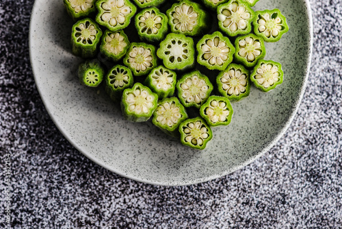 Overhead view of chopped okra on a plate photo