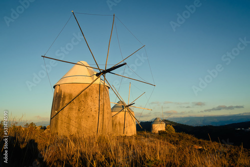 Tourist complex of old mills, in the sunset light. Evening landscape on top of a mountainous area