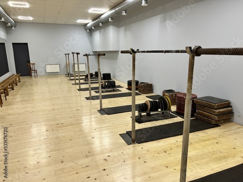 Equipment in gym. Modern fitness gym with large mirrors and exercise machines. Gym in the hotel. Training sports room for active training and pumping up muscles. Old rusty bars and pancakes for heavy 