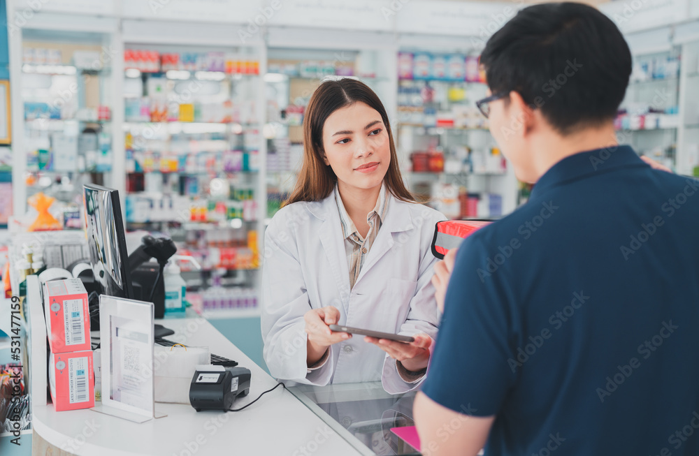 female pharmacist at drugstore.Health care pharmacists work at the hospital.Pharmacist looking at male customer.Doctor specialists organize prescription medications.